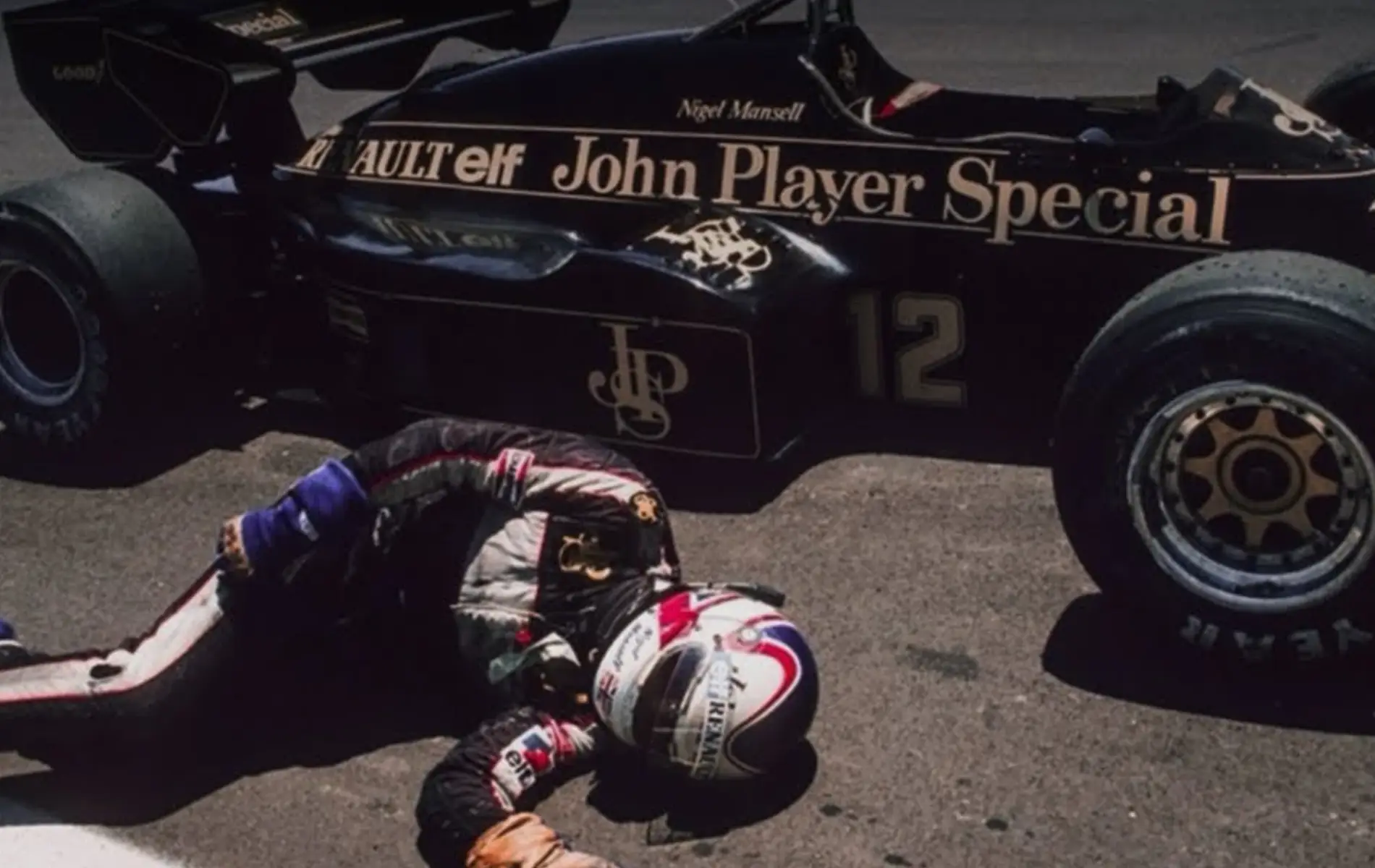 Nigel Mansell, collapsed with exhaustion while heroically trying to push his broken Lotus-Renault across the finish line at the 1984 Dallas GP.